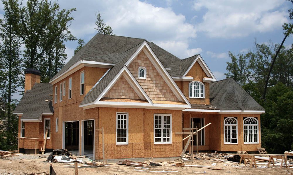 Builders Risk Coverage Understanding the Policy Period - Frontal View of a High Quality Home Under Construction on a Bright Afternoon